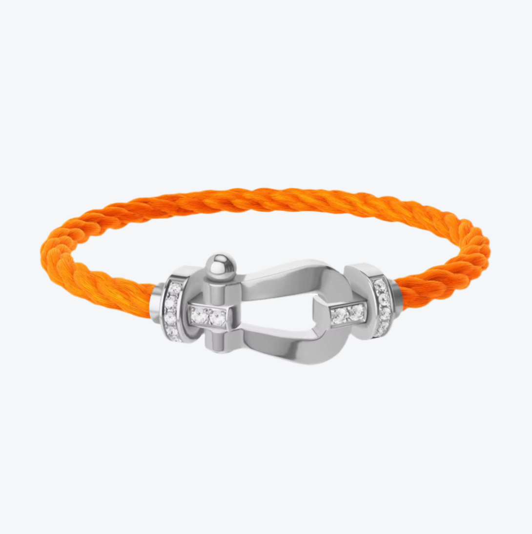 צמיד יוקרתי עם רצועת חבל כתומה ואבזם בגוון כסף משובץ בחצי זירקונים