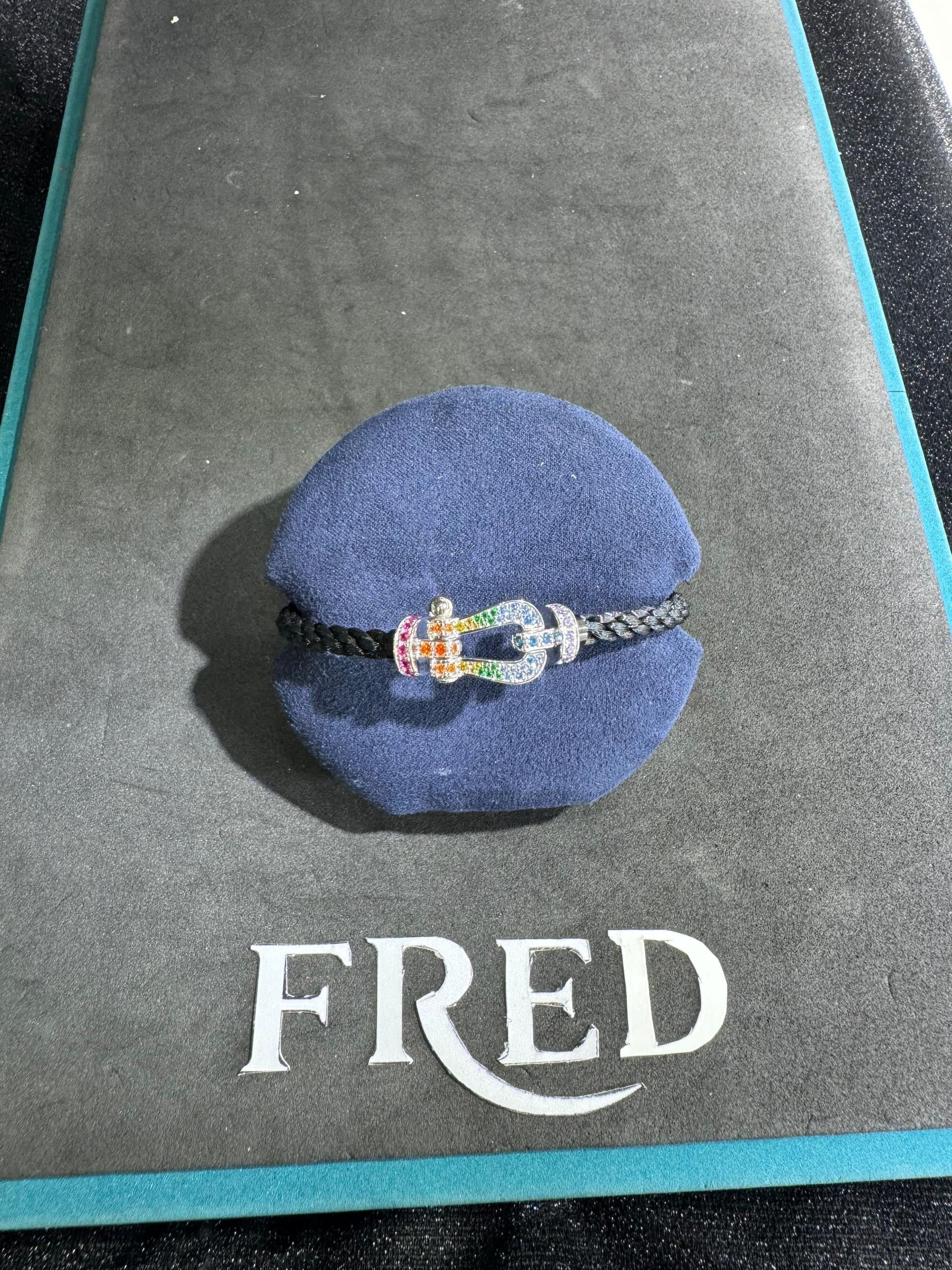 Luxurious bracelet with a black rope strap and a silver-tone buckle studded with sparkling zircons.— JEWELLUXE™