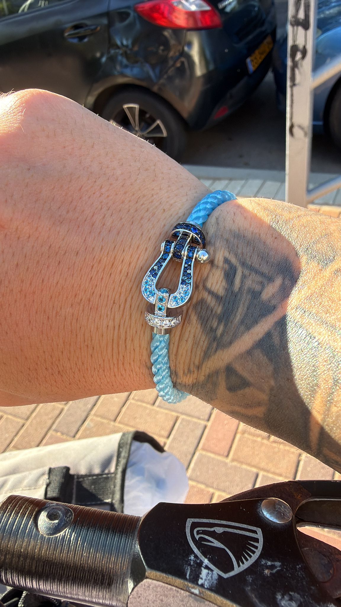 Luxury bracelet with a light blue rope strap and a silver-toned clasp studded with sparkling zircons — JEWELLUXE™