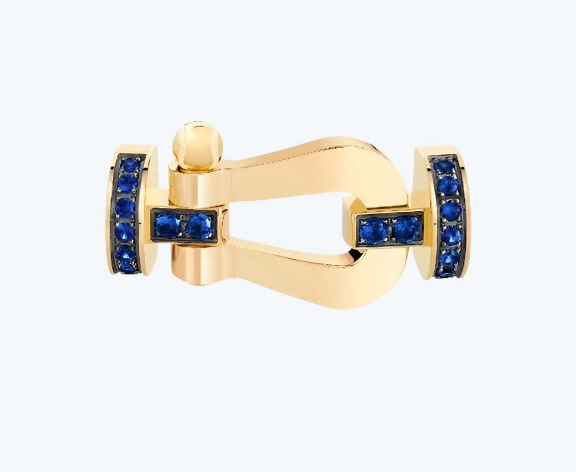 אבזם יוקרתי בגוון זהב – RG רולאן גארוס משובץ זירקונים כחולים