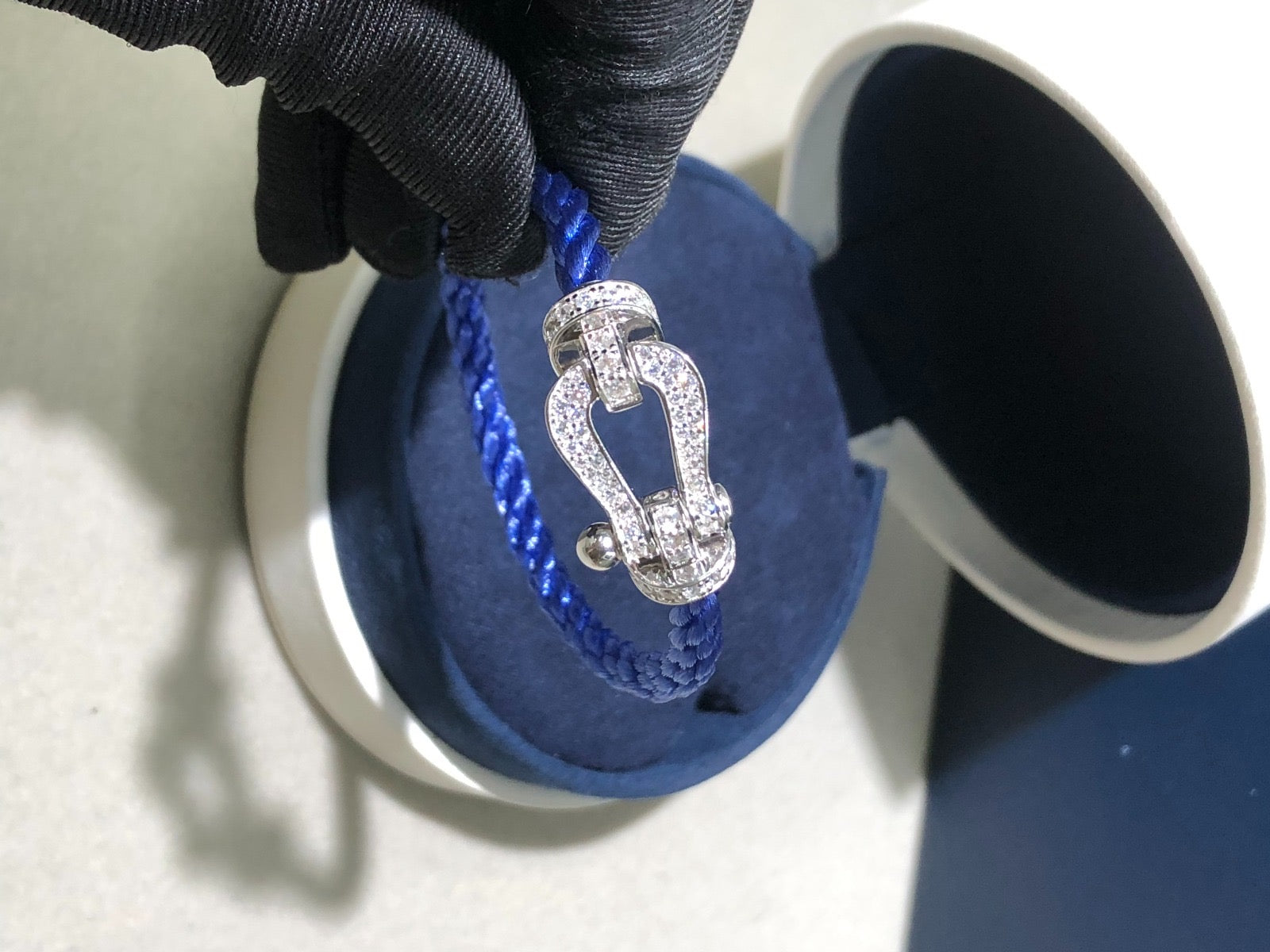 A luxurious bracelet with a blue rope strap and a silver-toned buckle set with sparkling zircons — JEWELLUXE™