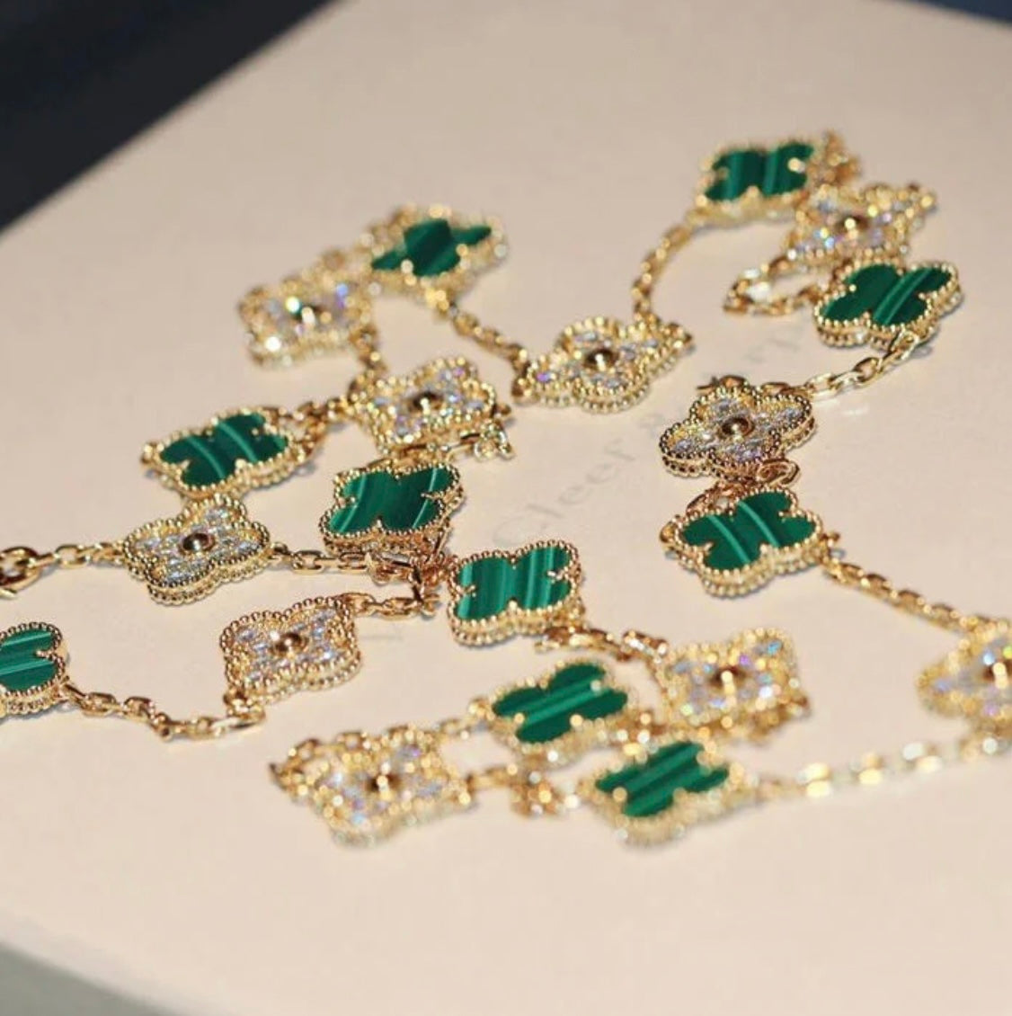 20-leaf clover necklace in gold with a green clover pendant studded with sparkling zircons