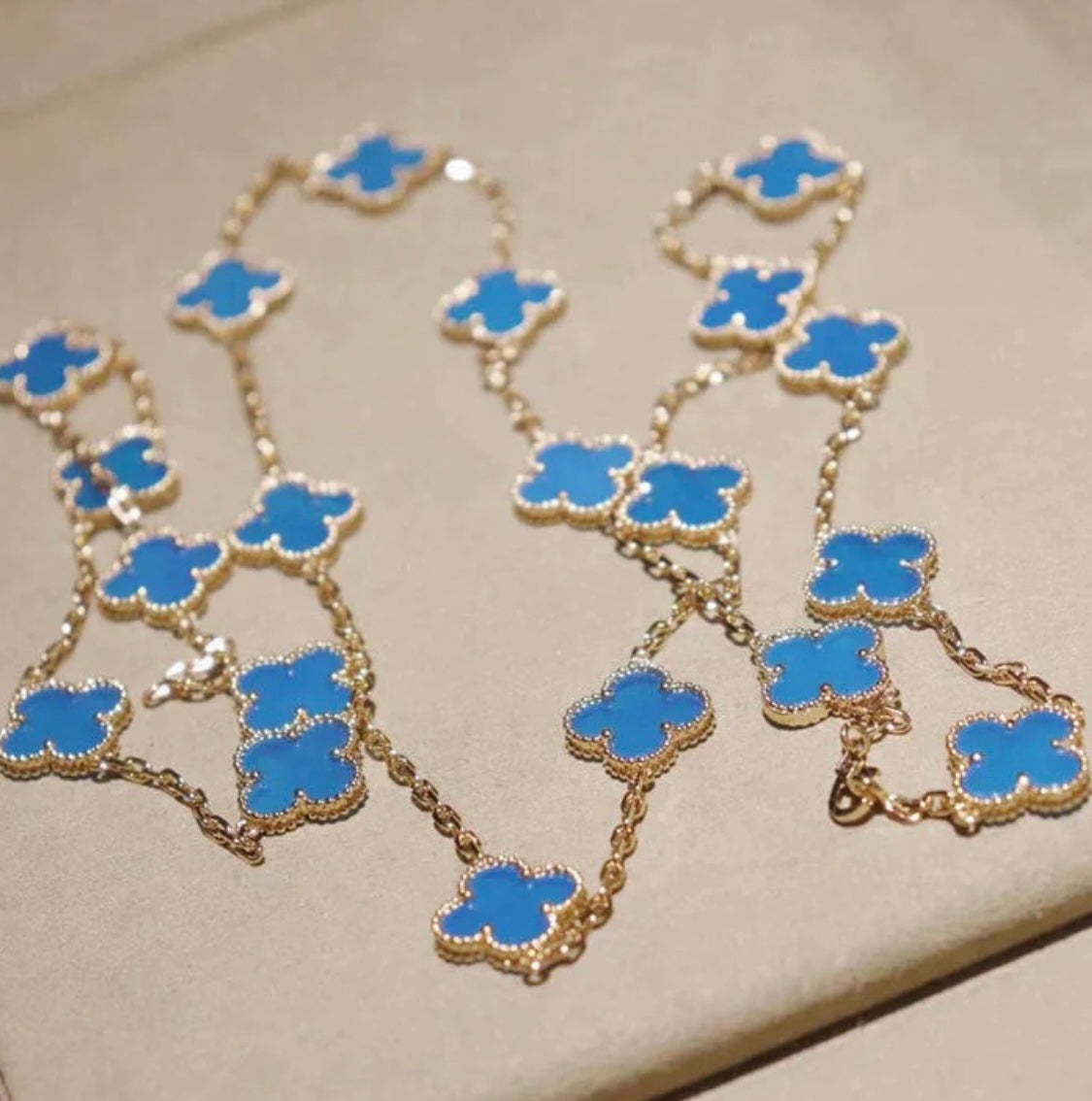 20-leaf clover necklace in gold with a blue clover pendant