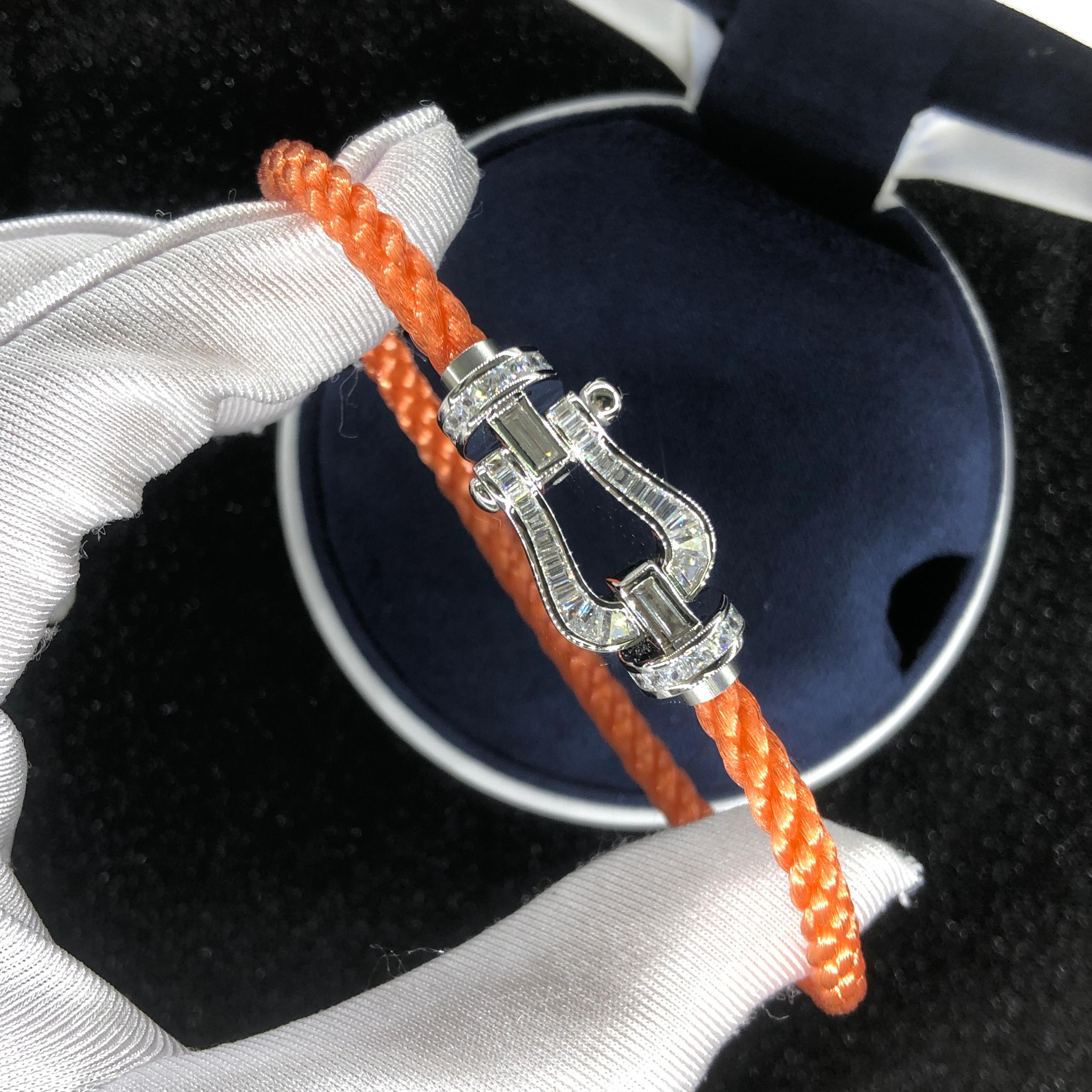 Luxurious bracelet with an orange rope strap and a silver-toned buckle set with sparkling crystals — JEWELLUXE™