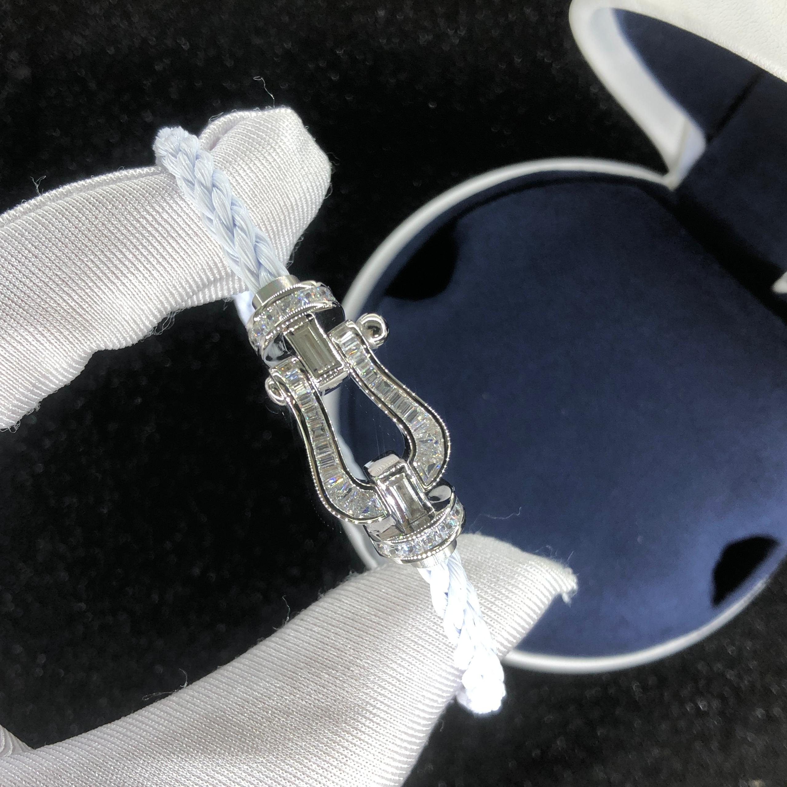 Luxurious bracelet with a white rope strap and a silver buckle studded with sparkling crystals