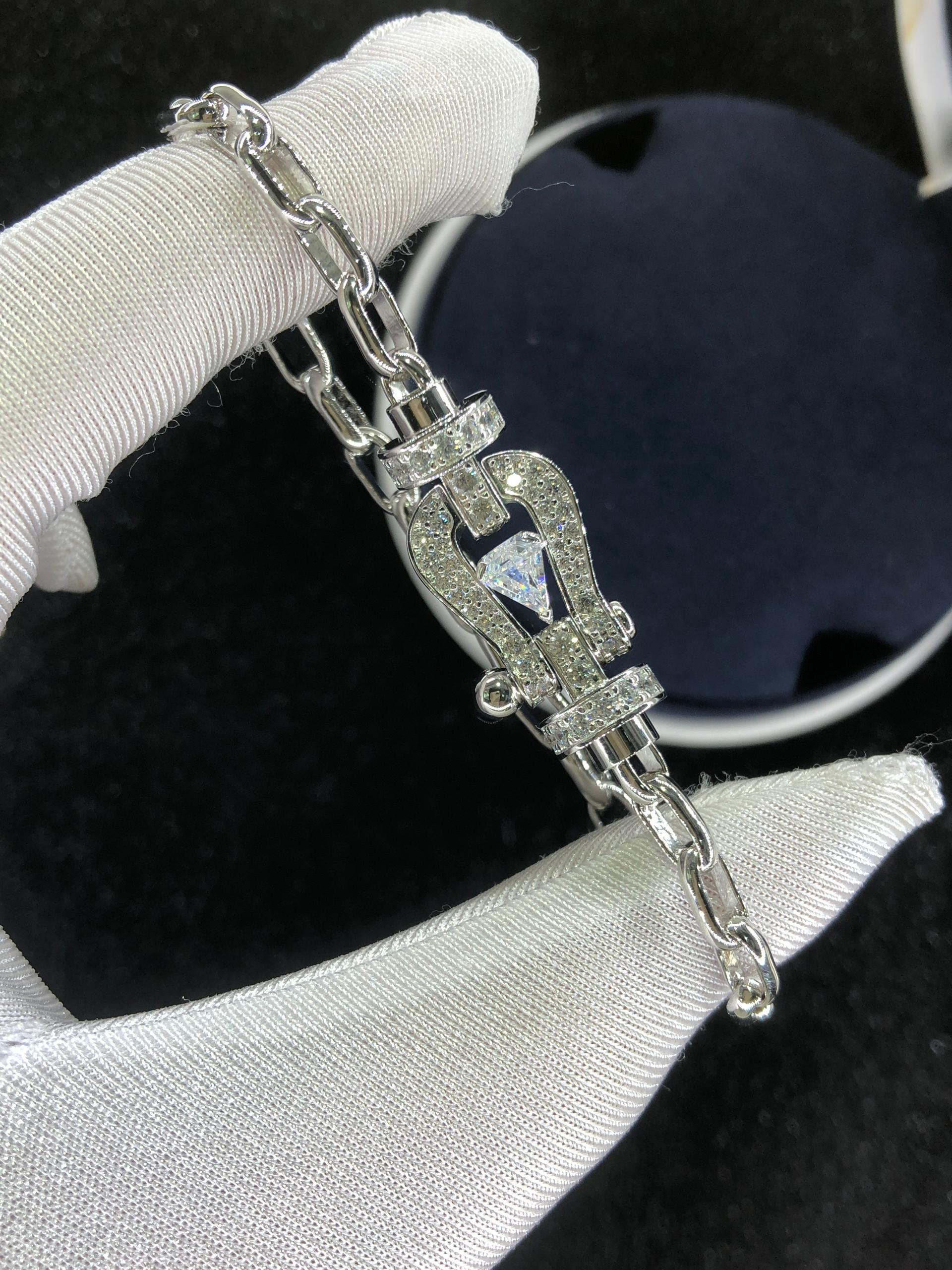 Bracelet luxueux avec une chaîne en argent et une boucle argentée parsemée de zircons, avec une pierre centrale de 0,5 carat