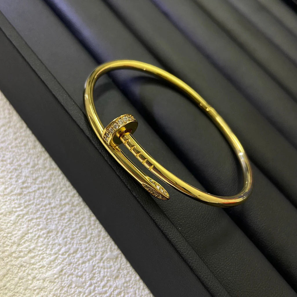 Elegantes Nagel-Armband in Goldoptik, halbseitig mit funkelnden Zirkoniasteinen besetzt — JEWELLUXE™