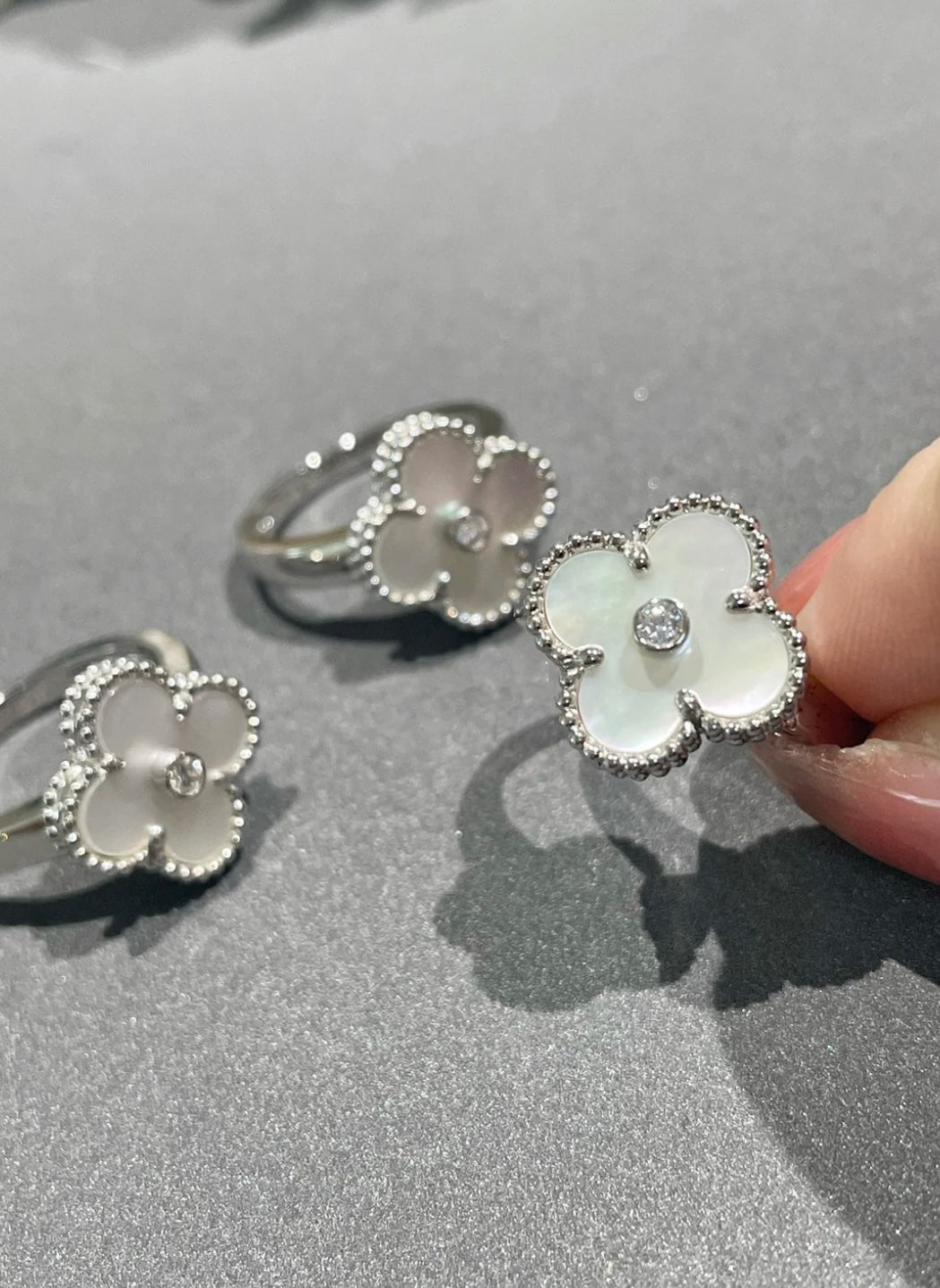 Weißer Kleeblatt-Ring, in der Mitte mit einem funkelnden Zirkon besetzt