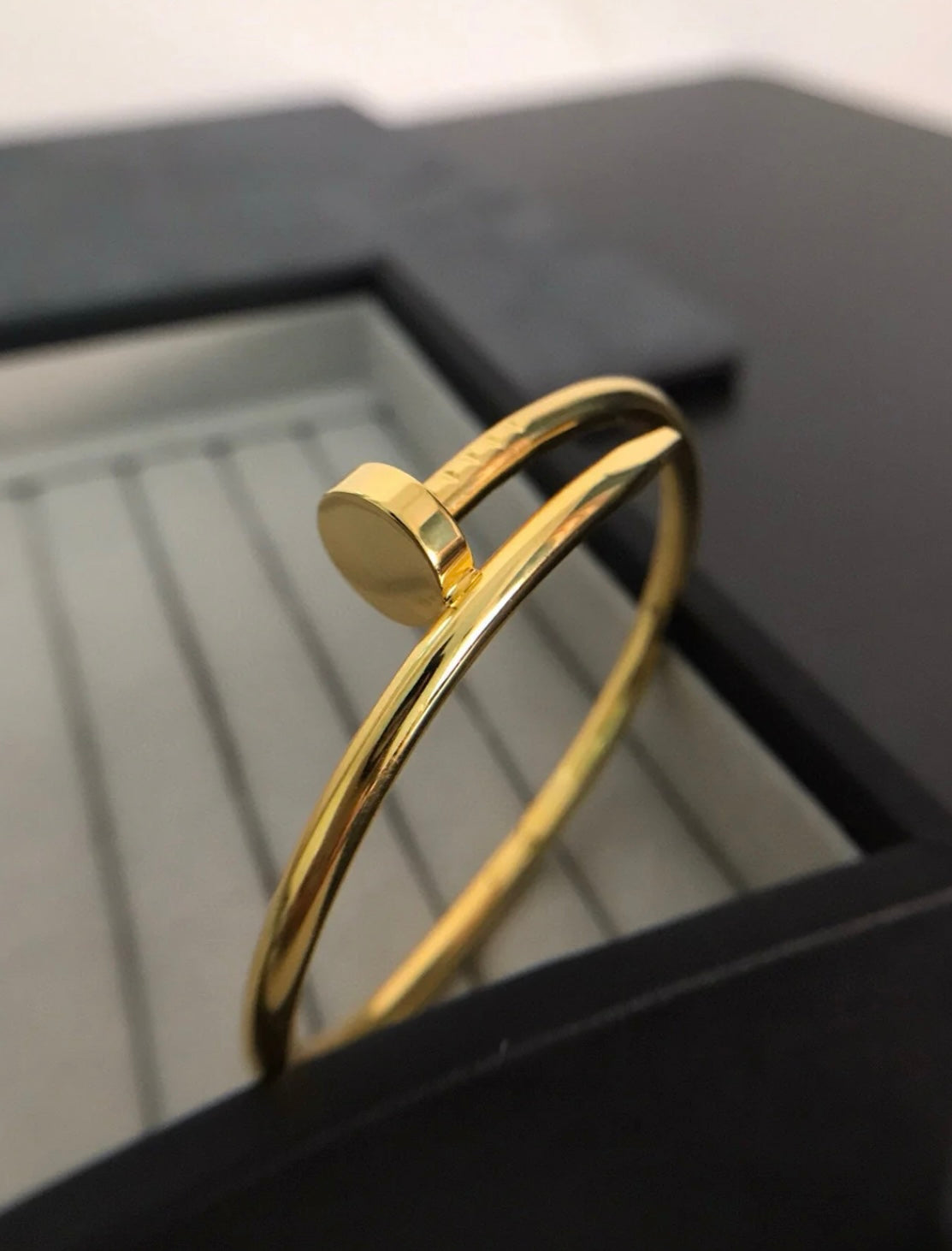 An elegant gold-tone nail bracelet with a touch of luxury