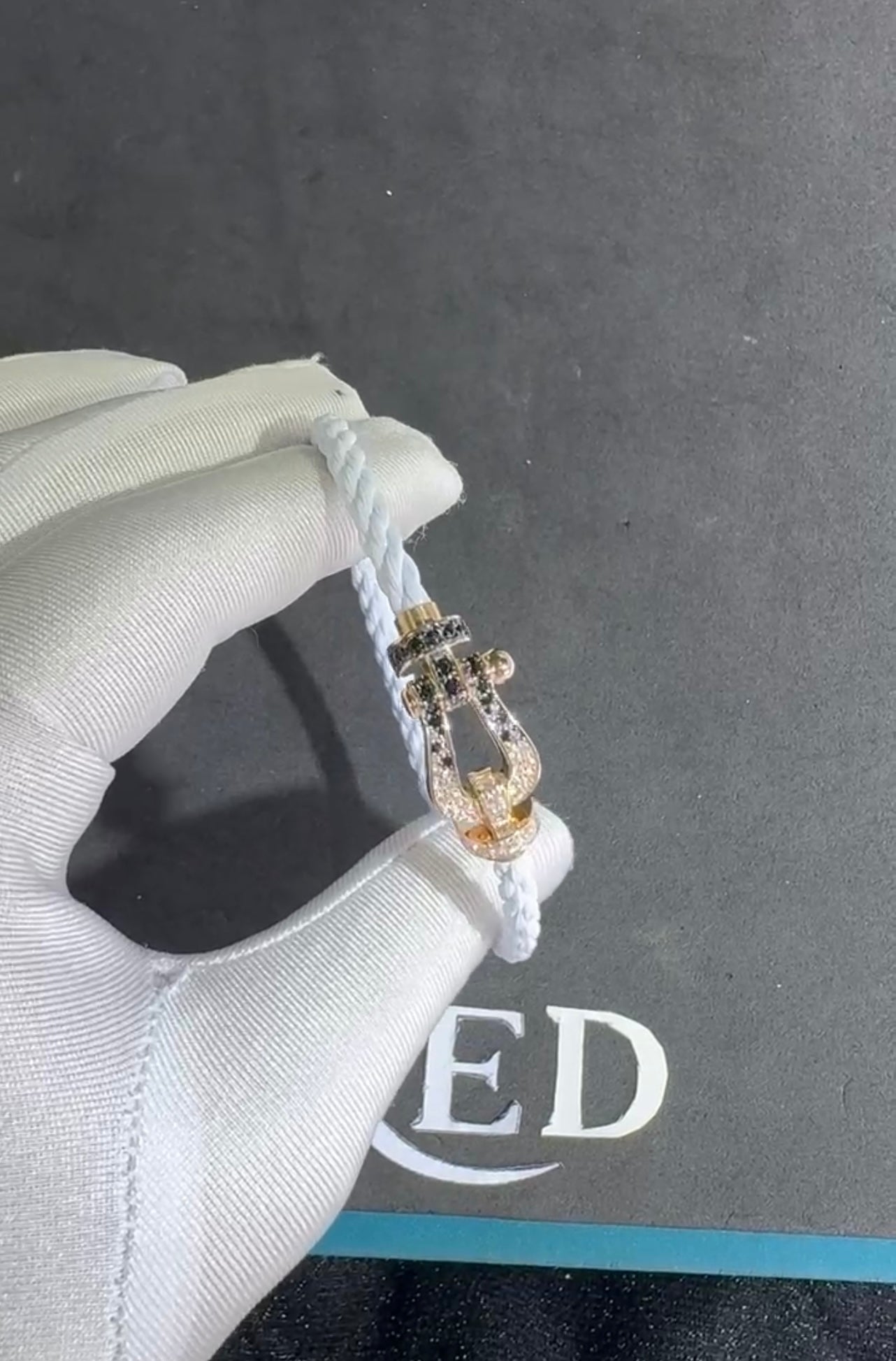 Luxury bracelet with a white rope strap and a rose-gold buckle set with black and white zircons — JEWELLUXE™